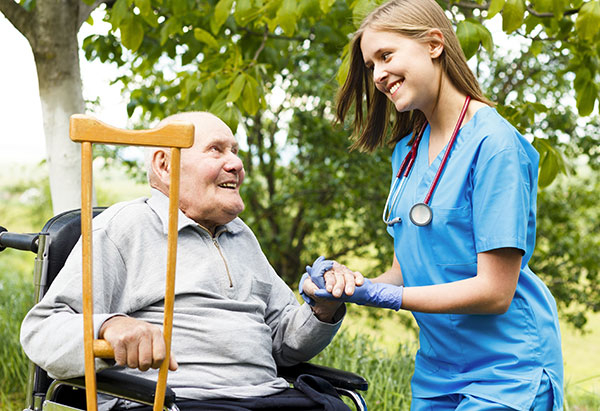 Contented senior patient with kind doctor at the nursing home.