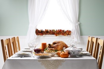 large table set for thanksgiving dinner