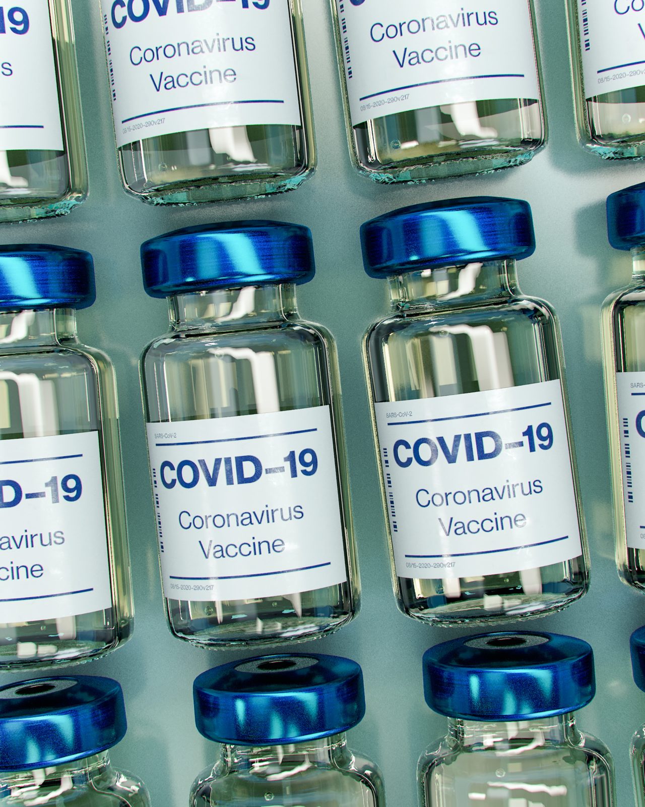 small glass vials with a Covid-19 vaccine label