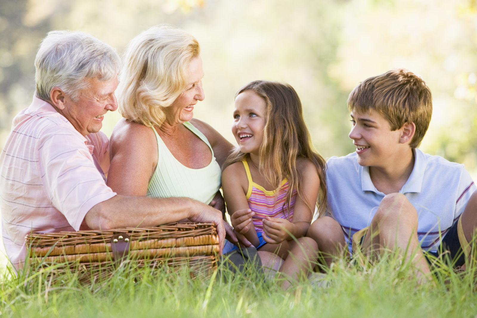 grandparents sitting in park with grandchildren