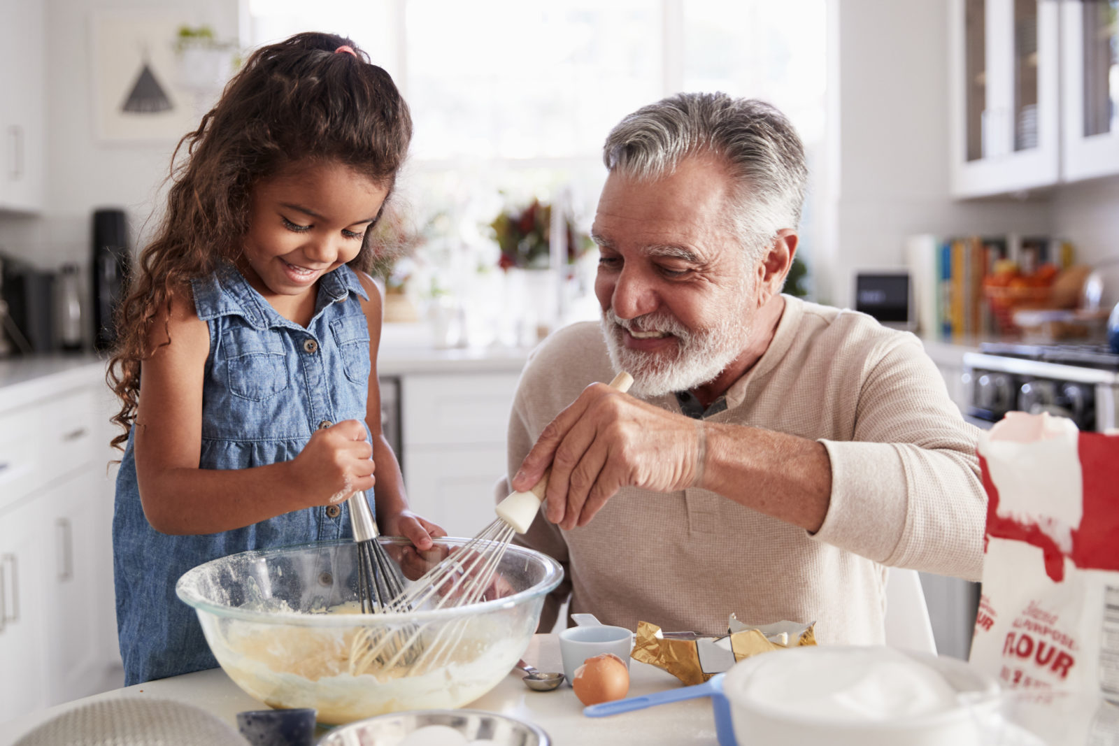 grandfather baking cookies with granddaughter