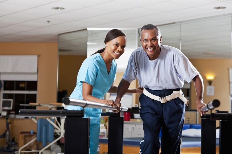 female Physical therapist helping patient through gait training