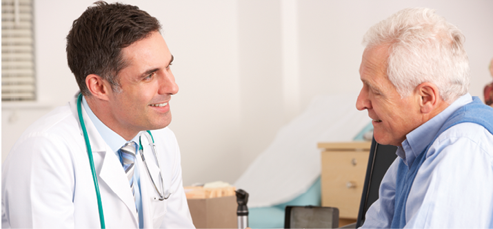 Male doctor talking to mature man in doctor's office