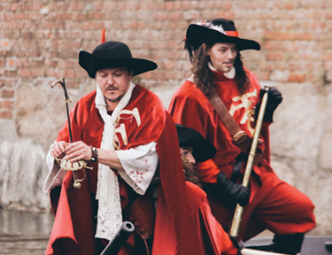 two men dressed in Shakespearean style costumes