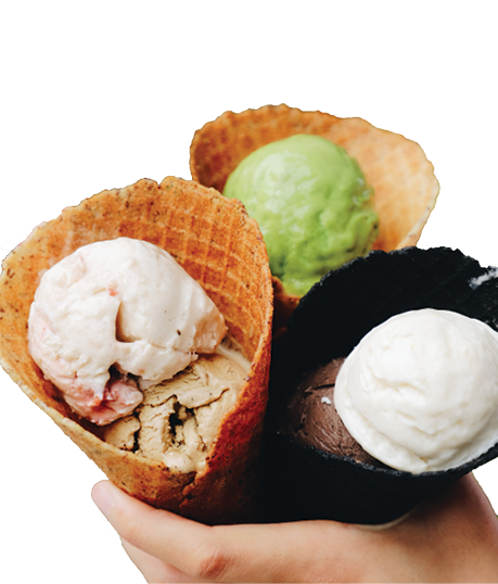 handing holding three scoops of ice cream in waffle cones