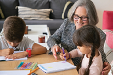 grandmother spending time with grandchildren at home drawing