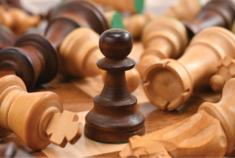 close up photo of dark and light wood chess pieces
