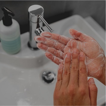 close up of hands washing in the sink