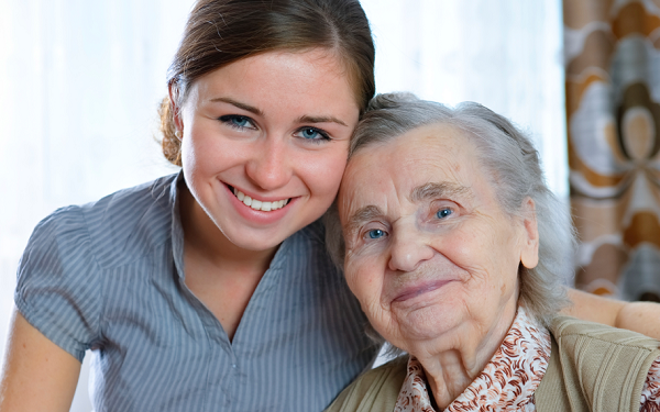 young woman smiling with older adult woman