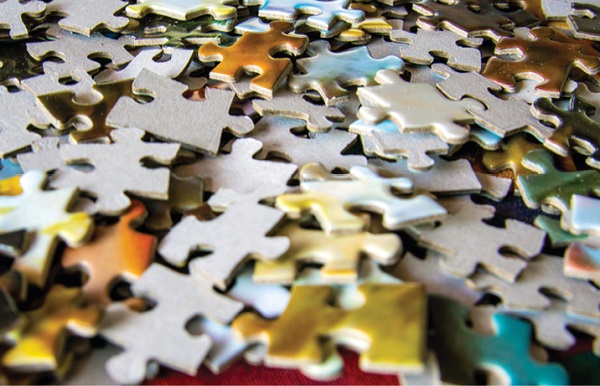 close up photo of jigsaw puzzle pieces in a pile