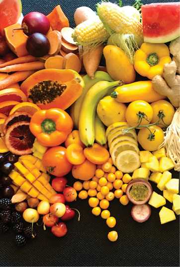 image of orange and yellow colored fruits and vegetables on a counter