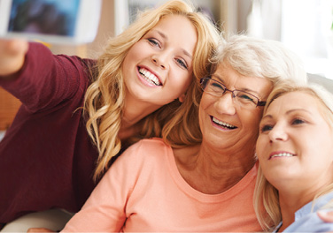 blonde girl taking selfie with mom and grandma