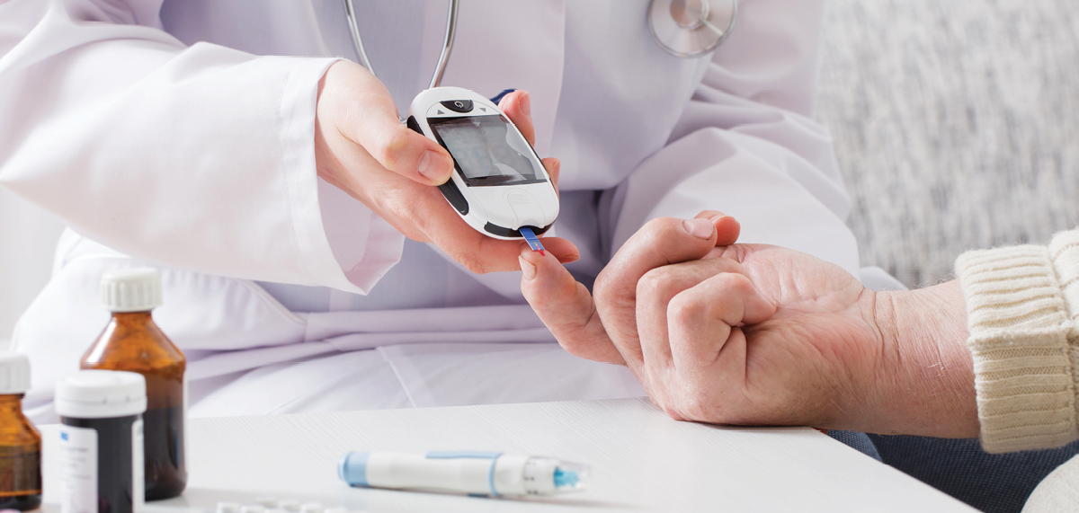 physician testing blood glucose of a patient