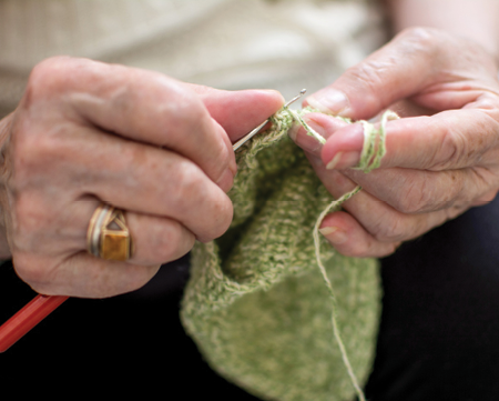 snapshot of woman's hands knitting