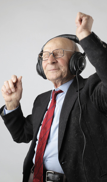 senior man wearing headphones and dancing