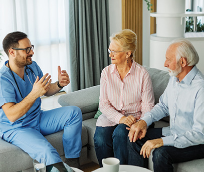 male doctor speaking with senior couple about healthcare decisions